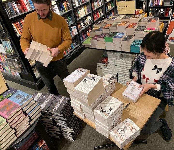 two people are looking at books in a bookstore