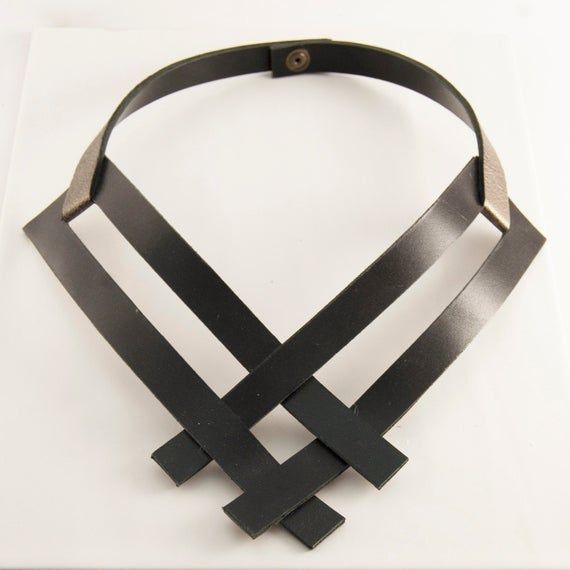 Our Contemporary Leather Necklace showcases a gorgeous large scale design, that is simple and charming. This elegant yet elaborate piece holds the simple side of things; while showing off a statement design. So you can enjoy the best of both worlds without going overboard. In addition, the contemporary leather necklace is manufactured using premium grade leather, that offers a charming finish. Modern Black Necklaces For Everyday Use, Elegant Metal Necklace For Everyday Use, Modern Black Necklace For Everyday Use, Modern Black Necklace For Everyday, Elegant Everyday Metal Necklace, Handmade Black Leather Necklace, Chic Handmade Leather Jewelry, Chic Black Jewelry For Everyday Use, Chic Black Everyday Jewelry