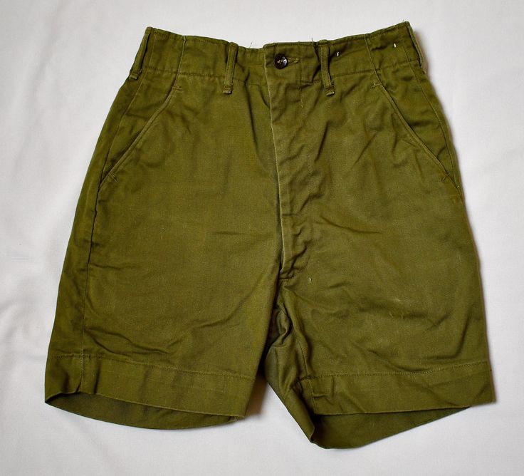 A pair of vintage 1960s or 70s khaki green cotton twill boy's or girl's military style Boy Scouts Uniform shorts.The shorts have a contoured waist with belt keepers and a fly zipper and button closure.  There are front diagonal pockets and two welt pockets at the back, one is button-through.  The shorts have been taken out at the back and the stitch marks are visible (please see the last photo).  There is a pale scuff mark on the right front leg near the hem.  No rips or holes.  25 inch waist33 inch hips, 4 1/2 inch inseam, 16 inches from the waist to the hem. 10 oz. Please also follow me on Instagram at ChrisMartinDesigns Scouts Uniform, Boy Scout Uniform, Scout Uniform, Style Boy, Military Style, Clothing Sets, Boy Scouts, Khaki Green, Military Fashion