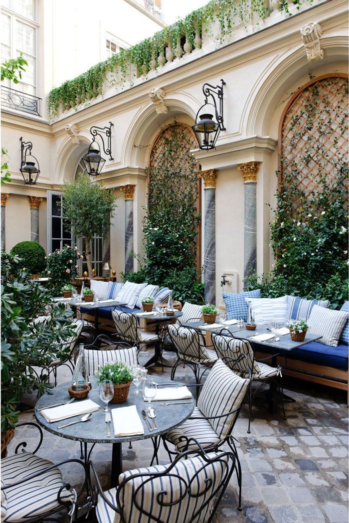 an outdoor seating area with tables and chairs