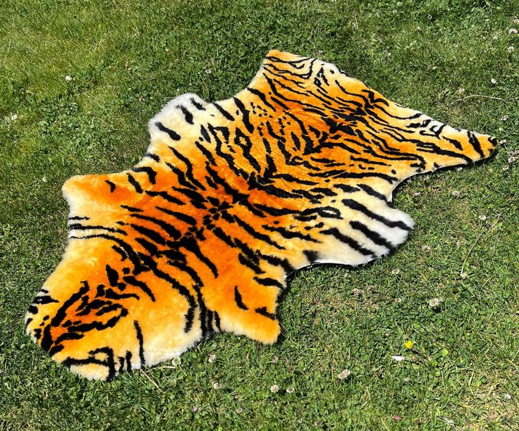 a tiger print rug is laying on the grass