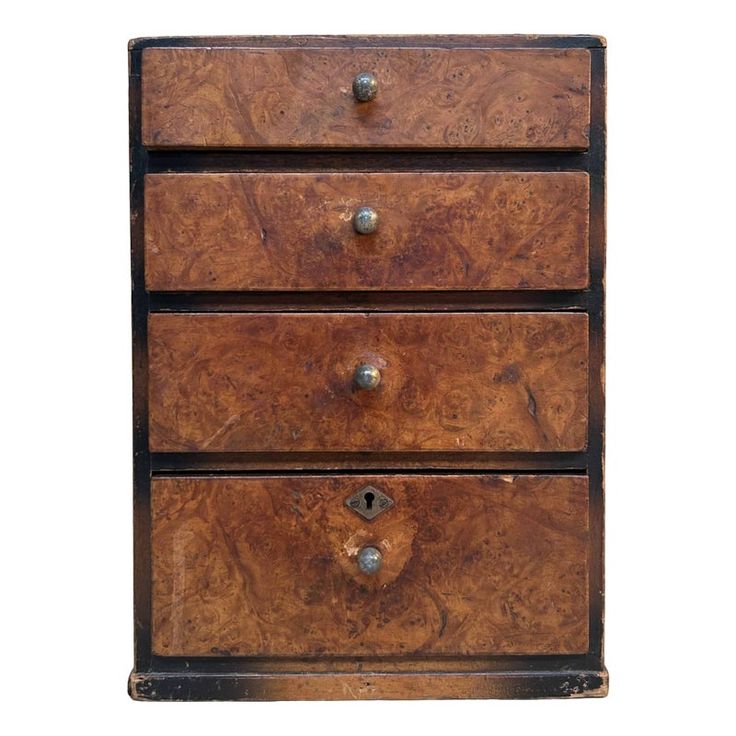 an old wooden dresser with three drawers and metal knobs on the bottom, against a white background