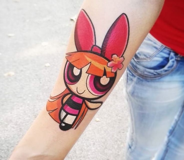 a person with a cartoon character tattoo on their arm