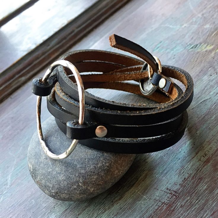 "This wrap statement bracelet is the perfect addition to your jewelry staples. Made with 1/4\" strips of handcut leather and featuring a 1 1/2\" hammered ring in either antique brass or antique silver secured with matching rivets. The bracelet wraps around the wrist 4 times and secures with an adjustable closure. I use only genuine U.S. tanned leather from either Horween (Chicago) or Wickett and Craig (Pennsylvania). The leather will age beautifully, become buttery soft and develop fabulous char Modern Adjustable Double Band Bracelets, Adjustable Hand Wrapped Leather Wrap Bracelet, Adjustable Leather Bangle Bracelet For Everyday, Adjustable Silver Double Band Leather Bracelet, Adjustable Double Band Silver Leather Bracelet, Double Band Leather Strap Jewelry, Silver Adjustable Double Band Leather Bracelet, Adjustable Wrap Bangle Bracelet, Adjustable Modern Leather Bangle Bracelet