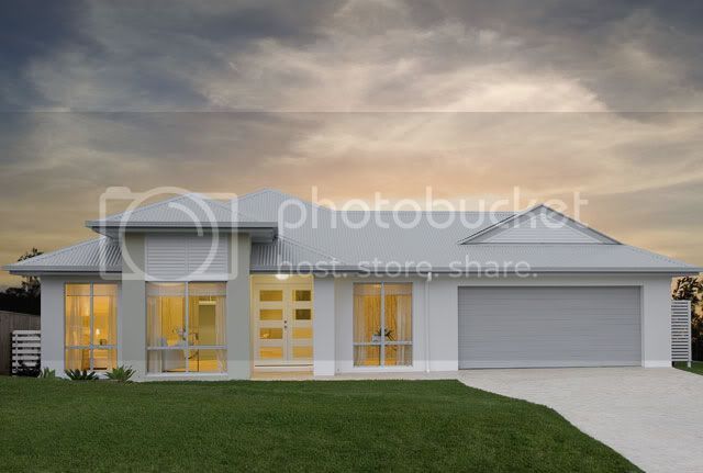 a white house sitting in the middle of a lush green field under a cloudy sky