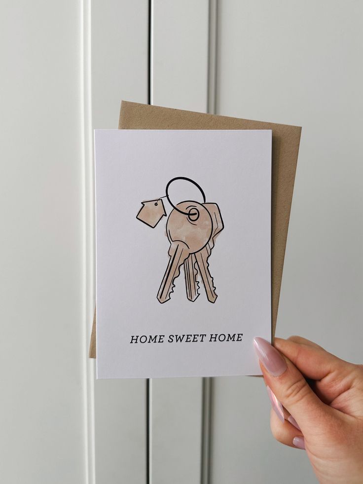 a hand holding up a card that says home sweet home