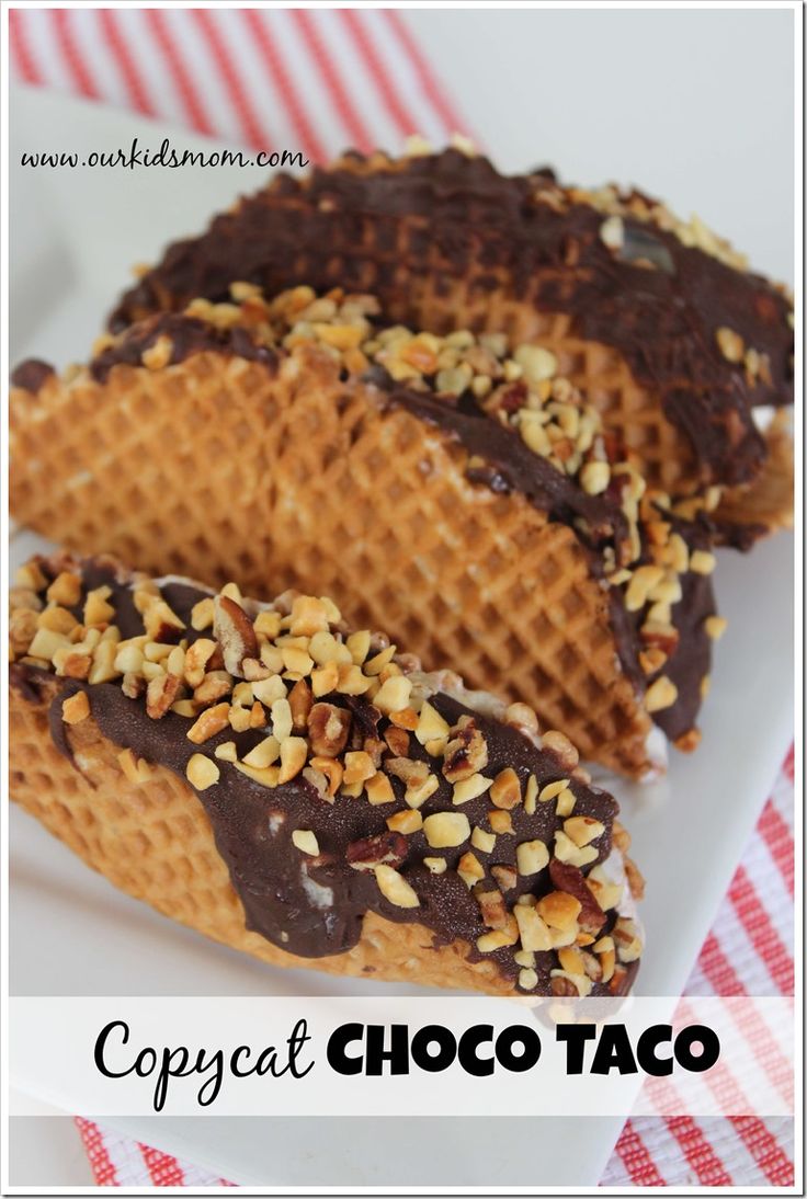 two waffles with chocolate and nuts on top are sitting on a white plate