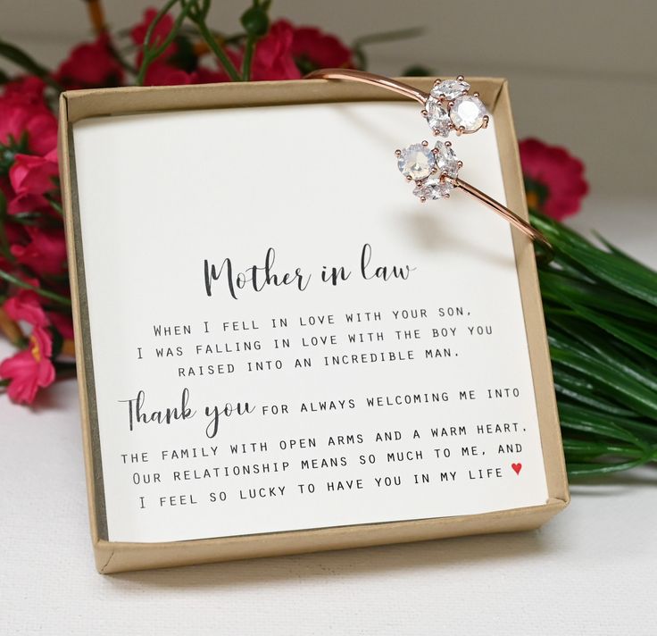 a mother's love poem in a box with flowers behind it and a flower bouquet