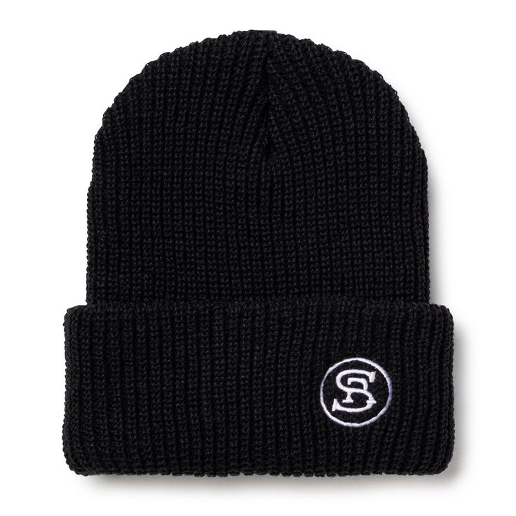 a black beanie with a white logo on the front and bottom, it is knitted