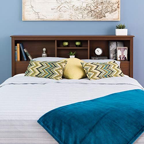 a bedroom with blue walls and a large map on the wall above the headboard