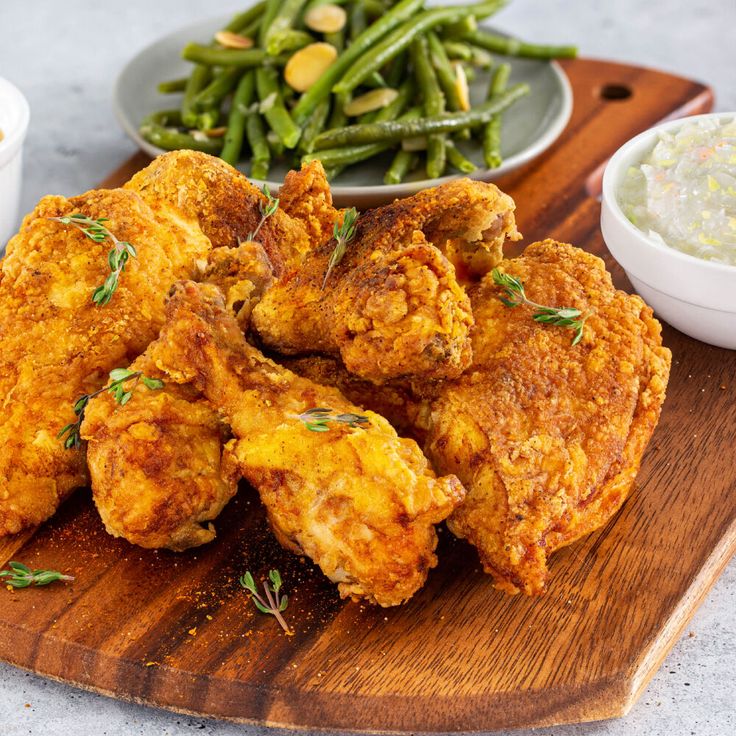 fried chicken and green beans on a cutting board