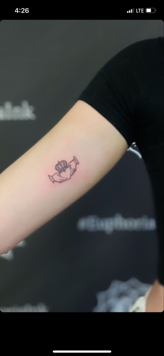 a woman's arm with a small tattoo on the left side of her arm