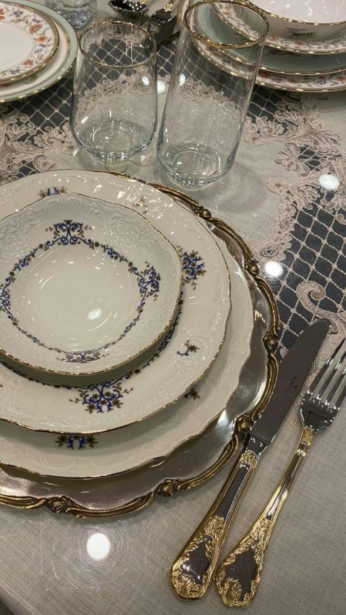 the table is set with dishes and silverware