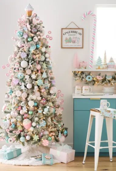 a white christmas tree with pink and blue ornaments