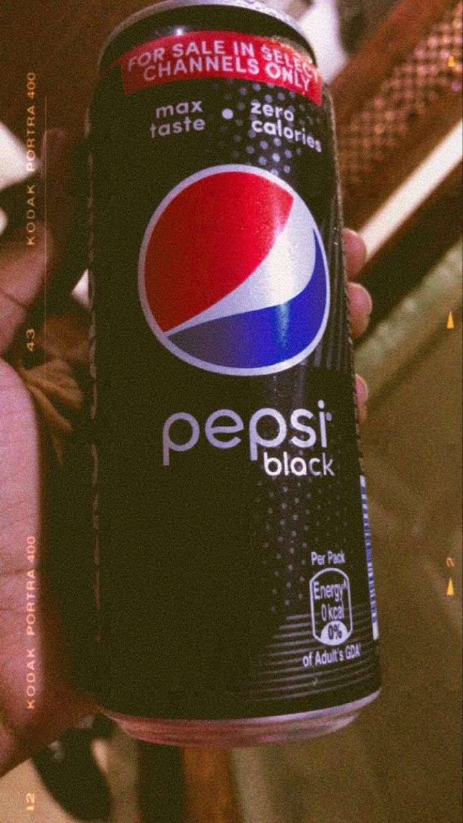 a can of pepsi is in someone's hand with the caption pepsi black