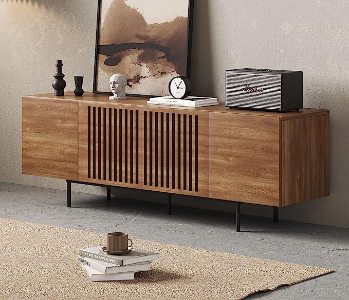 a wooden sideboard sitting on top of a rug next to a wall mounted clock