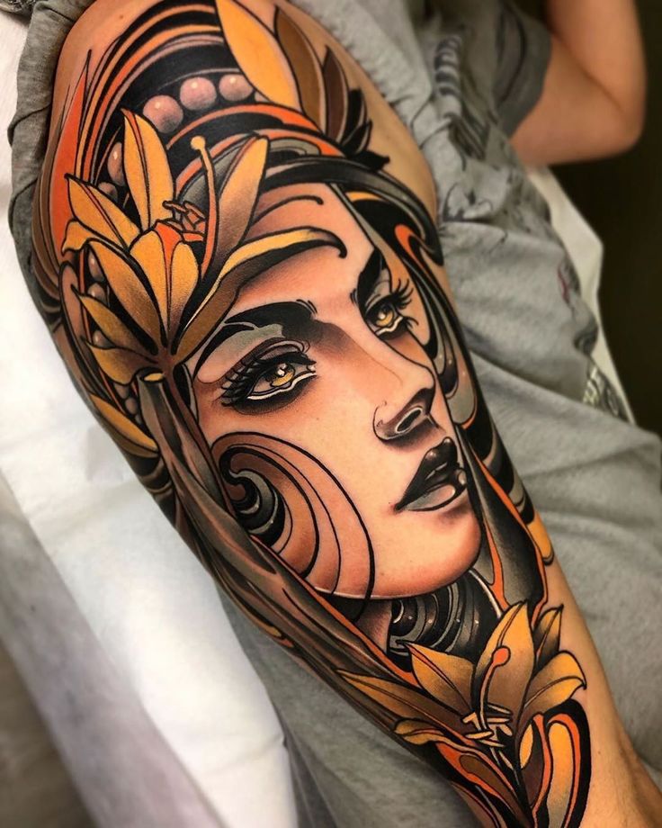 a woman's face with flowers on her arm