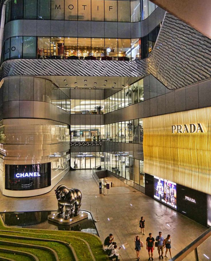 the inside of a shopping mall with people walking around