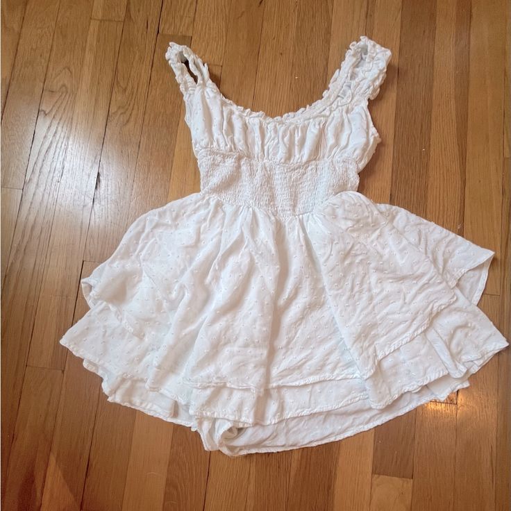 This Dress Is Completely New, Having Never Been Worn Before. The Dress Is Light And Flowy, Making It Perfect For Both Formal And Casual Events. Comes With Built-In Shorts, And Can Be Worn Both On And Off The Shoulder. (Originally Retails At Urban Outfitters For $70 Usd) Cute Fitted Mini Dress With Smocked Bodice, Cute Fitted Sundress With Smocked Back, Cute Mini Dress With Smocked Bodice For Day Out, Cotton Mini Dress With Smocked Back For Casual Wear, White Cotton Mini Dress With Smocked Back, Urban Outfitters Flirty Sleeveless Mini Dress, White V-neck Mini Dress By Urban Outfitters, Flowy Cotton Mini Dress With Smocked Back, White Fitted Mini Dress With Smocked Back