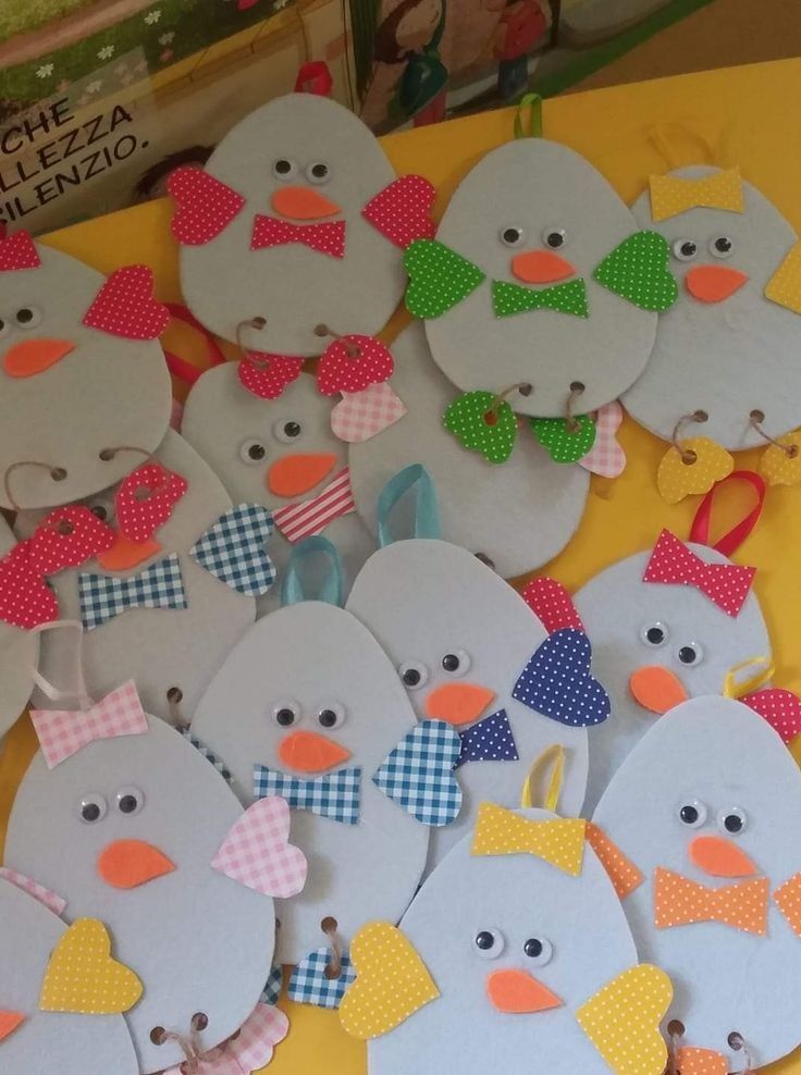 some paper cut outs that are shaped like penguins with bow ties and bows on them