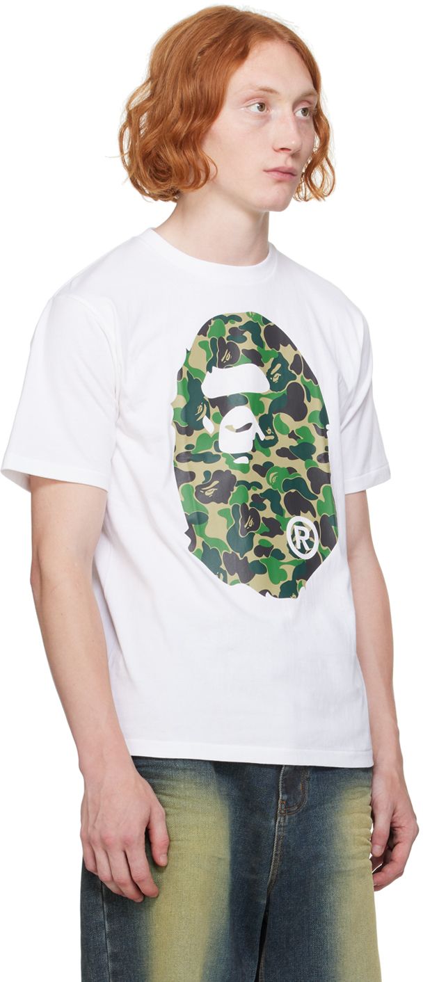 Cotton jersey T-shirt. · Rib knit crewneck · Logo graphic printed at front and back · Logo flag at cuff Supplier color: White X green Camouflage Letter Print T-shirt For Streetwear, Camouflage Graphic Print T-shirt For Streetwear, Relaxed Fit Camouflage T-shirt With Graphic Print, Camouflage Sublimation Print Crew Neck T-shirt, Camouflage Crew Neck T-shirt With Sublimation Print, Camouflage Graphic Print Crew Neck T-shirt, Camouflage Crew Neck T-shirt With Graphic Print, Camouflage Graphic Print Relaxed Fit T-shirt, Camouflage Graphic Tee With Print