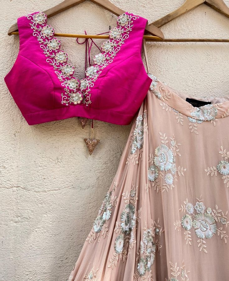 This exquisite Rani Pink and Tan Embroidered Lehenga Set with Ruffle Dupatta is a vision of elegance, combining the charm of traditional craftsmanship with modern style. Made from georgette fabric, the tan umbrella lehenga features intricate sequin and thread work floral motifs, beautifully accentuated by a wide, shimmering gota border in gold and vibrant pink, adding a regal touch to your look. Paired with a striking rani pink raw silk blouse, it dazzles with its plunging neckline adorned with Silk Lehenga With Mirror Work For Party, Silk Choli With Mirror Work For Party, Elegant Pink Choli With Mirror Work, Pink Silk Choli With Mirror Work, Pink Dola Silk Choli With Mirror Work, Pink Silk Choli For Parties, Pink Silk Choli For Party, Embellished Pink Blouse Piece For Diwali, Festive Pink Embellished Blouse Piece