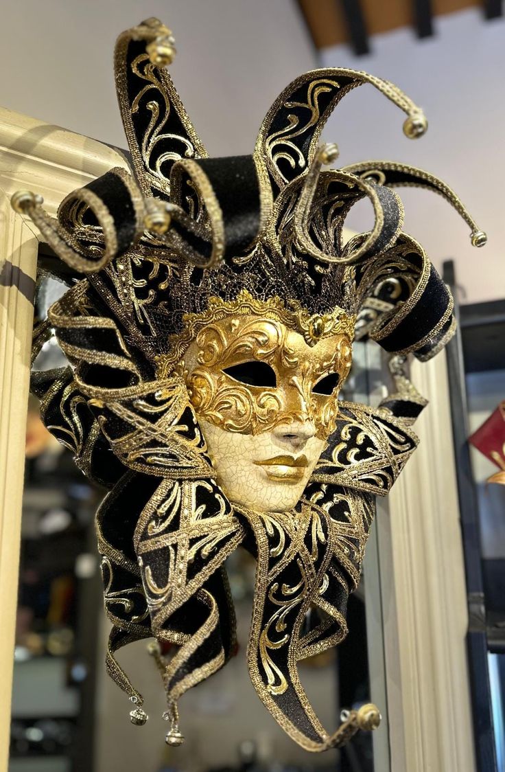 Handmade Venetian mask of the Jester, decorated with gold leaf, antique crackling and a gold trim. The pointed headpiece is made of black velvet and has golden bells. This type of mask is also named Venetian-wall mask because it can be used very successfully as a wall decoration and wall art, but the Jester mask can also be used for events like Mardi Gras, Venetian carnival, masked balls, masquerade balls or bal What a. Two ribbons are attached for wearing. beautiful mask also a special father d Venetian Jester, Venetian Masks Art, Jester Mask, Mask Ball, Venetian Masquerade Masks, Venice Mask, Venetian Carnival Masks, Jester Hat, Ren Fair