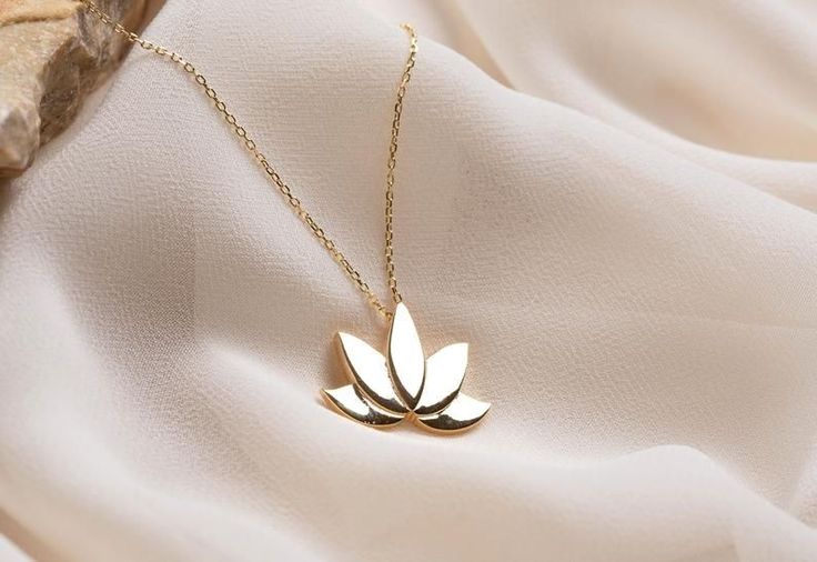 This Lotus Necklace and chain are 14K Solid GOLD ( not filled or plated). Solid Gold Lotus Pendant in 14K Yellow Gold, 14K Rose Gold, 14K White Gold. #lotusnecklace #lotuspendant #lotuscharm #flowernecklace #namastenecklace #giftsforbestfriend #womannecklace #14kgoldjewelry #solidgoldnecklace #necklaceforwomen #goldpendant #romanticgifts #giftforher #goldjewelrygift #christmasgift #valentinesdaygift #etsyseller #etsyjewelry #mothergift #birthdaygift Formal Gold Jewelry With Flower Charm, Gold Jewelry With Flower Charm, Gold Hallmarked Flower-shaped Jewelry, Gold Flower Necklace In 14k Gold, Fine Gold Jewelry With Flower Charm, Elegant Gold Flower Necklace As Gift, Elegant Gold Flower Necklace Gift, Elegant Gold Flower Necklace For Gift, Elegant Tarnish Resistant Flower-shaped Necklaces