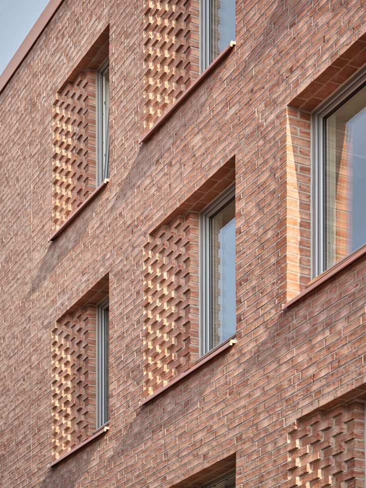 the side of a brick building with several windows