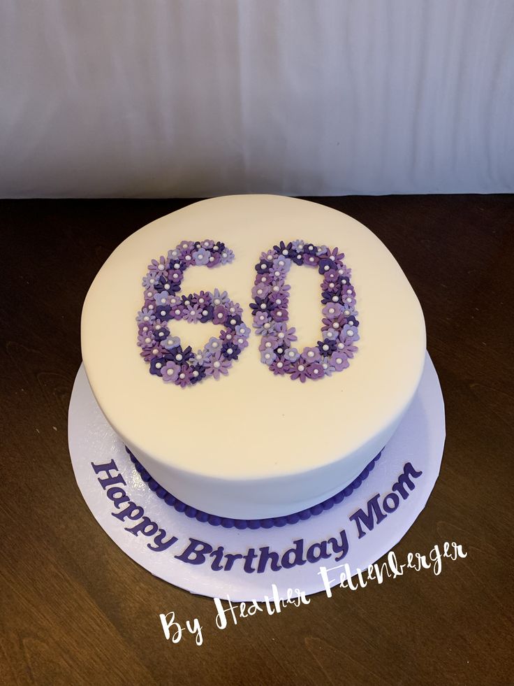 a birthday cake with the number sixty on it's side and purple beads in the middle