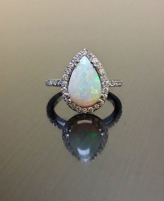 14K White Gold Opal Diamond Engagement Ring Art by DeKaraDesigns Silver Pear-shaped Halo Ring For Wedding, Pear-shaped Silver Halo Ring For Wedding, White Gold Pear-shaped Halo Wedding Ring, Pear-shaped White Gold Halo Wedding Ring, White Diamond Opal Ring With Halo Design, White Opal Ring With Diamond Halo Design, Fine Jewelry Pear-shaped Halo Ring For Wedding, White Opal Ring With Diamond Halo Setting, Sterling Silver Pear-shaped Diamond Wedding Ring