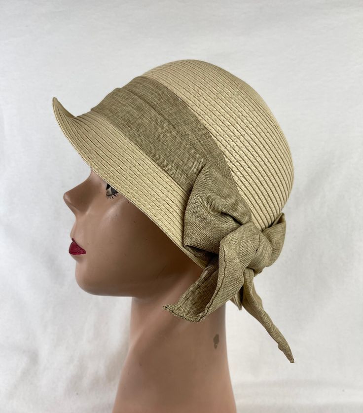 This soft Toyo Straw vintage-inspired natural beige cloche hat is lightweight and the hat will fit up to 22 5/8 inch head size which an inside sizing cord to adjust to your head size. The brim is 2 inches wide. The crown is about 4 1/2 inches tall. The bow band is made from cotton and linen blend material. NOTE: Please check the head size before purchase, I am happy to answer any questions you may have. There will be a 20% restocking fee for all returned hats. Classic Cloche Hat For The Beach, Cream Fedora Sun Hat For Kentucky Derby, Beige Cloche Hat For Vacation, Cream Brimmed Fitted Sun Hat, Cream Fitted Brimmed Sun Hat, Kentucky Derby Cream Fedora Sun Hat, Fitted Cream Brimmed Sun Hat, Adjustable Cream Bucket Hat, Beige Mini Bucket Hats For Spring