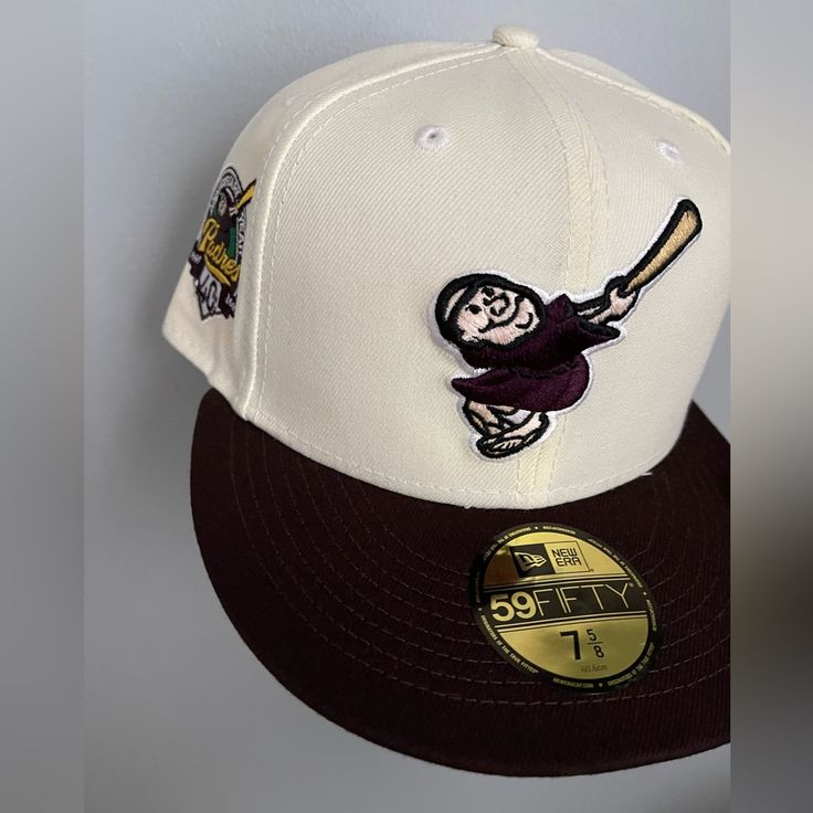 a baseball cap with an image of a man holding a bat on it's side