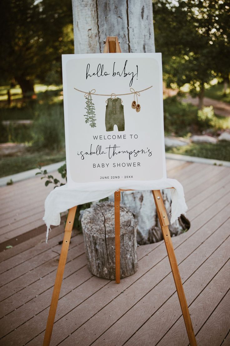 a welcome sign on an easel for a baby shower