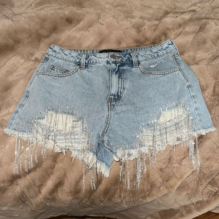 Denim Shorts With Silver Sparkly Fringe At Front Distressed Casual Denim Bottoms For Party, Casual Denim Party Bottoms, Summer Party Cutoff Bottoms, Casual Cutoff Bottoms For Party, Party Cutoff Denim Shorts, Casual Silver Denim Bottoms, Blue Denim Bottoms For Party, Short Denim Jeans For Party, Denim Party Shorts