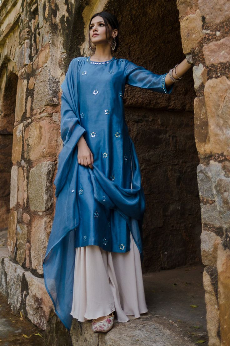 Blue kurta with mirror work embroidered motifs. Paired with gharara and dupatta.
Component: 3
Embroidered
Neckine: Round
Sleeve Length: Three quarter
Fabric: Chanderi, Crushed Cotton
Color: Blue
Chanderi dupatta - Aza Fashions Mirror Work Shirt Design, Mirror Work Embroidery, Blouse Yoke, Chanderi Dupatta, Mirror Work, Kurta Set, Elegant Dress, Indian Outfits, Aza Fashion