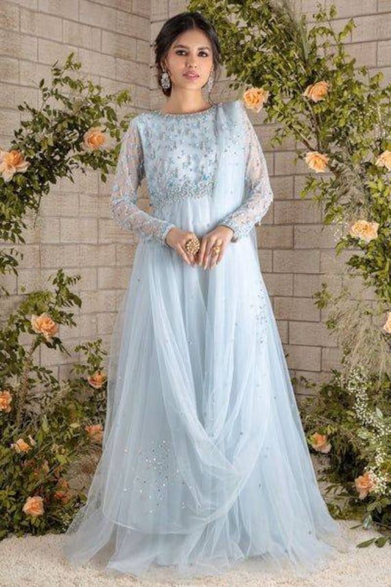 Ice blue floor length tulle gown with  beads , sequin and pearl hand embroidery. This beautiful gown is perfect for wedding, aniversary and formal functions  ✨This dress can be customise in any other colour and in all size, please contact us regarding any changes if you want.We will make this dress as per your choice. ✨We use high quality fabric and threads for embroidery.You won't face any problem in future regarding fading of colour or anything. You can use this outfit for many years.  ✨There may be slight colour difference due to high quality camera resolution and other filters. Rest every thing will be same.  🌸Care Instructions Dry clean only Floor-length Gown With Sheer Bodice, Princess Style Floor-length Wedding Dress For Prom Season, Princess Ball Gown For Wedding And Prom Season, Organza Dress With Fitted Bodice Floor-length, Floor-length Organza Dress With Fitted Bodice, Organza Ball Gown For Prom Season, Floor-length Ball Gown With Sheer Bodice, Anarkali Hand Embellished Organza Wedding Dress, Hand Embellished Maxi Evening Dress For Reception