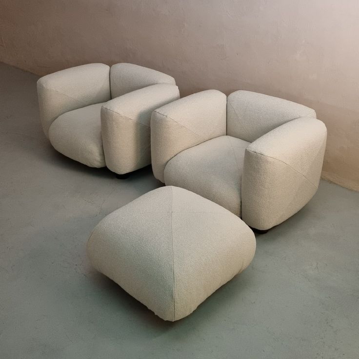 a group of white chairs sitting next to each other on top of a cement floor