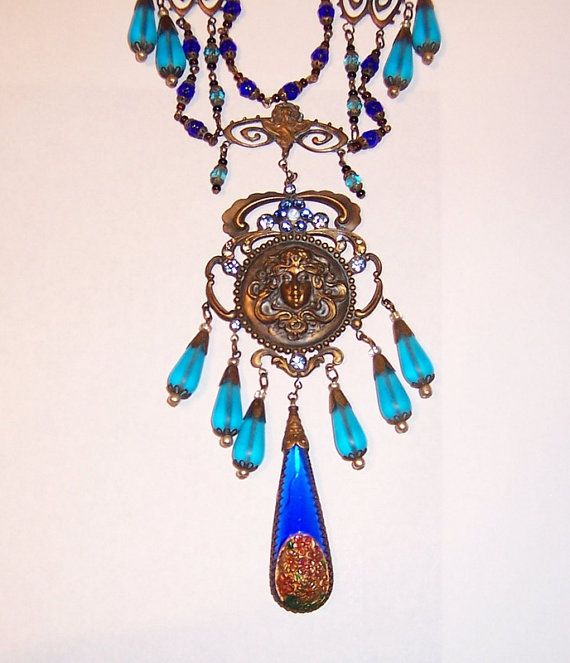 This an outstanding turquoise and cobalt blue Czechoslovakian bib necklace. The design and their attention to detail truly exemplify their craftsmanship. The necklace measures 16 in length and is stamped on the reverse side of the large medallion. This exquisite necklace is in excellent vintage condition. N.J. State residents please add the applicable 7% N.J. State Sales Tax. Ornate Blue Pendant Necklace, Antique Blue Jewelry With Large Pendant, Antique Handmade Blue Turquoise Necklace, Vintage Blue Turquoise Necklace For Jewelry Making, Handmade Antique Blue Turquoise Necklace, Vintage Turquoise Necklace For Jewelry Making, Antique Blue Turquoise Necklace Gift, Antique Blue Pendant Necklace, Antique Blue Turquoise Necklace For Gift