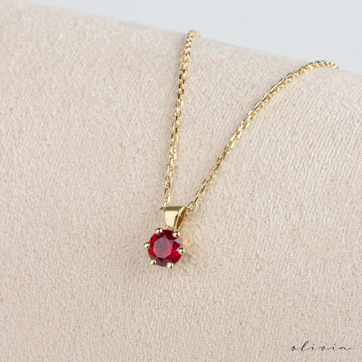 "Elevate your elegance with our Dainty Ruby Gold Pendant Necklace, featuring a captivating ruby set in 14K solid gold. Symbolizing July's birthstone, this exquisite solitaire pendant exudes timeless grace. A perfect gift for a cherished mother, celebrating her birth month with sophistication and style. F E A T U R E S 💠 G E M S T O N E Type: Ruby Carat: 0.50  ,  0.30  ,  0.15   options Cut: Round 🌟 M A T E R I A L Gold: Available in 14K and 18K Options Color: Choices of White, Rose, or Yellow Chain: Cable Closure: Spring Ring **The model on the mannequin in the images is the 0.50 carat model. 🎁 Extra Touch: As a testament to our dedication to exceptional customer service, each purchase is accompanied by a complimentary product certificate. Your order will be elegantly presented in a sty Classic Red 14k Gold Necklace, 14k Gold Birthstone Necklace With Round Stone, Elegant Gold Plated Round Birthstone Necklace, Dainty Ruby Gemstone Birthstone Necklace, Fine Jewelry With Lab-created Ruby In Yellow Gold, Elegant Ruby Birthstone Necklace, Yellow Gold Jewelry With Lab-created Ruby, Fine Jewelry Yellow Gold Lab-created Ruby, 14k Gold Birthstone Necklace With 17 Jewels