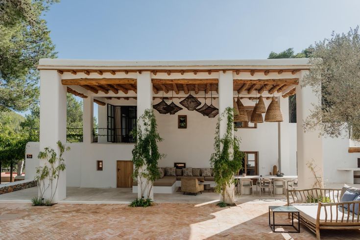 an outdoor living area with chairs and tables