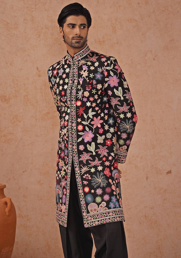 Make a bold statement in the Black Embroidered Sherwani. Crafted from luxurious Georgette, the sherwani features intricate resham and sequinned embroidery, detailed cuffs and collar, and a pure lining. Completed with matching embroidered pants and dupatta. Ideal for Cocktail parties. Composition : Sherwani, Patiyala & Dupatta : Viscose Georgette Care: Dry Clean Only and Vacuum Storage This product can be customized for sleeves, length and colour Delivery : 2-4 weeks as the product is hand crafte Bollywood Style Bandhgala With Floral Embroidery For Festivals, Designer Nehru Jacket With Intricate Embroidery, Bollywood Bandhgala With Floral Embroidery For Festive Occasions, Traditional Fit Sherwani With Resham Embroidery For Festivals, Embroidered Bollywood Sherwani With Traditional Fit, Traditional Fit Embroidered Bollywood Sherwani, Bollywood Style Embroidered Sherwani, Designer Nehru Jacket With Intricate Embroidery For Festive Occasions, Bollywood Bandhgala With Floral Embroidery For Transitional Season