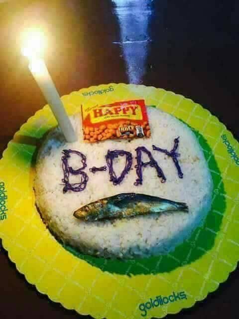 a birthday cake with the word b - day written on it and a lit candle