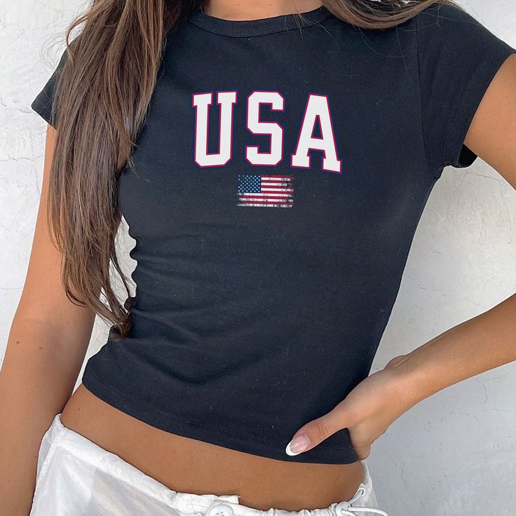 USA Flag Baby Tee, Distressed 4th of July Crop Top, Retro USA BabyTee, Y2k Usa Flag Tee, Usa shirt, 4th of july flag Shirt, Merica Shirt  ------------------------------------------------- This youth-sized baby tee brings back the classic 90's style. It's a miniature version of a t-shirt, distinct from modern crop tops. Be sure to check the size chart before purchasing to ensure the perfect fit. 📏 SIZING: The Gildan 5000B is a "youth" t-shirt. Reflecting the authentic baby tees of the 90s, it re Labor Day Cotton Tops Made In Usa, Cotton Tops Made In Usa For Labor Day, Independence Day Crew Neck Tops Made In Usa, American Style Flag Print Top For 4th Of July, American Flag Print Tops For Independence Day, Labor Day Americana Style Cotton Tops, Labor Day Americana Cotton Tops, Cotton Americana Tops For Independence Day, Independence Day Americana Cotton Tops