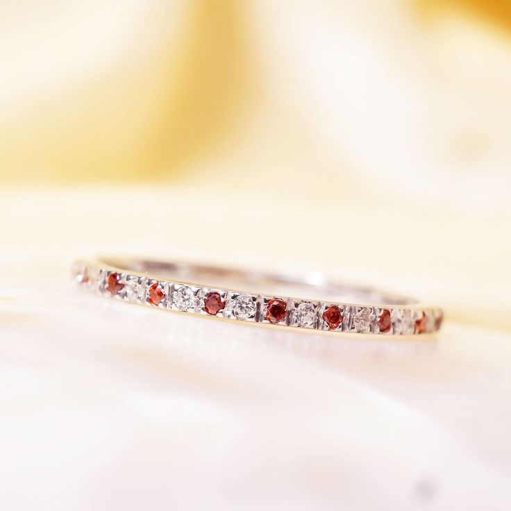 "Materials Gold, Rose gold, White gold Garnet and Diamond Eternity Band / 14k White Gold Micro Pave Diamond and Garnet Eternity Wedding Ring/ Garnet Wedding Band / Full Eternity Item Features Features * Made to Order * Material: 14K Solid Gold (If 18K is needed, please inquire) * Gold Color Choice: Rose Gold, Yellow Gold, White Gold * Gemstone Cut: Round * Gemstone: White Diamonds and Ruby * Diamond Color: j Color * Diamond Clarity: SI (TRUE SI) * Setting Type: U Setting Micro Pave * Number of S Elegant Red Eternity Band For Anniversary, Red Diamond Wedding Ring With Accents, White Half Eternity Band For Wedding, White Round Eternity Band For Wedding, White Halo Eternity Band For Anniversary, Fine Jewelry Eternity Band With Halo Design For Wedding, Wedding Eternity Band In Diamond White With Halo, Wedding Diamond White Eternity Band With Halo, Wedding Eternity Band With Halo Design