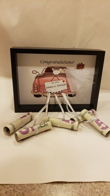 three rolled up candy sticks sitting on top of a white table next to a framed picture