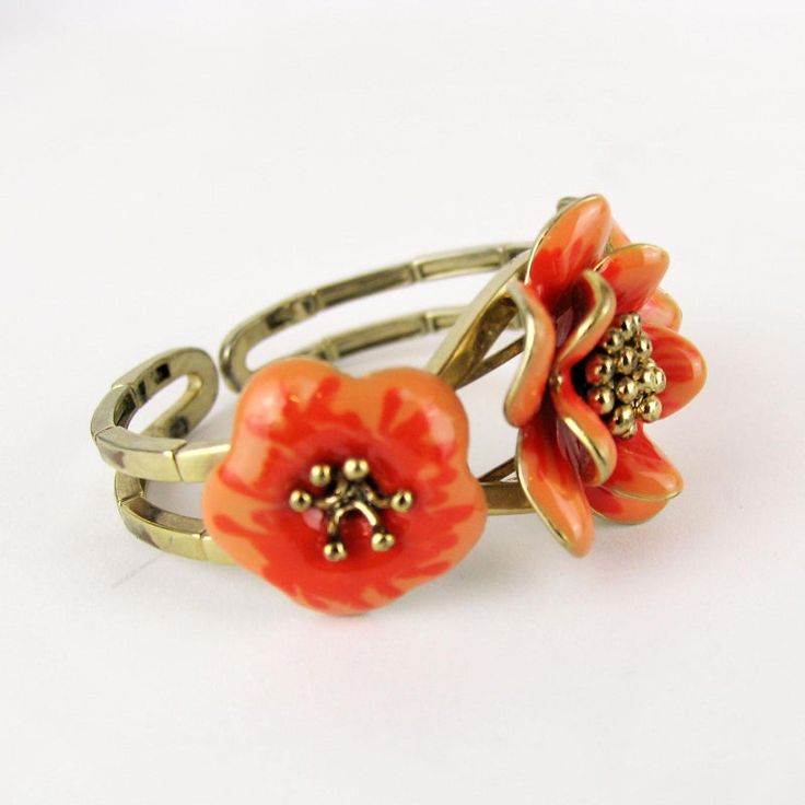 Gorgeous vintage articulated bracelet with enameled flower.       Condition:  Very good preowned condition.  Creator: -  Materials and Techniques:  metal, enamel  Marks:    Date (~):  1960s  Place of Origin:  France  Measurements: Diameter interior 5,5 cm, middle flower 3,5 cm  Weight: circa 70 gr Adjustable Flower Shaped Metal Ring, Adjustable Metal Flower Ring, Unique Enamel Flower Shaped Jewelry, Unique Enamel Flower Jewelry, Vintage Orange Flower Jewelry, Orange Vintage Flower Jewelry, Vintage Enamel Flower Ring For Gift, Adjustable Vintage Enamel Bracelets, Retro Handmade Flower Jewelry