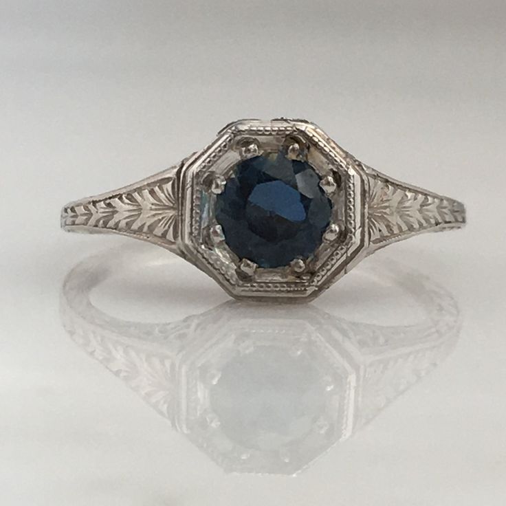 Details: Stunning Art Deco Period platinum and sapphire ring--would make a lovely wedding ring! The center stone is estimated .40 carats, and measures 4.9mm round. The filigree is beautiful on this ring, and is in lovely shape. This is a stunning ring--you will not be disappointed! Please ask all necessary questions prior to placing an order. Measurements: The size is 5 1/2 US and can be sized for a fee. Condition: The overall all condition of this ring is very good. Asscher Cut Sapphire Ring With Diamond Detail, Sapphire Color Emerald-cut Diamond Ring In Platinum, Emerald-cut Sapphire Diamond Ring In Platinum, Platinum Sapphire Diamond Ring With Brilliant Cut, Emerald Cut Sapphire Diamond Ring In Platinum, Classic Formal Diamond Ring With Lab-created Sapphire, Brilliant Cut Sapphire Diamond Ring In Platinum, Sapphire Diamond Ring With Brilliant Cut In Platinum, Art Deco Sapphire Ring With Platinum Center Stone