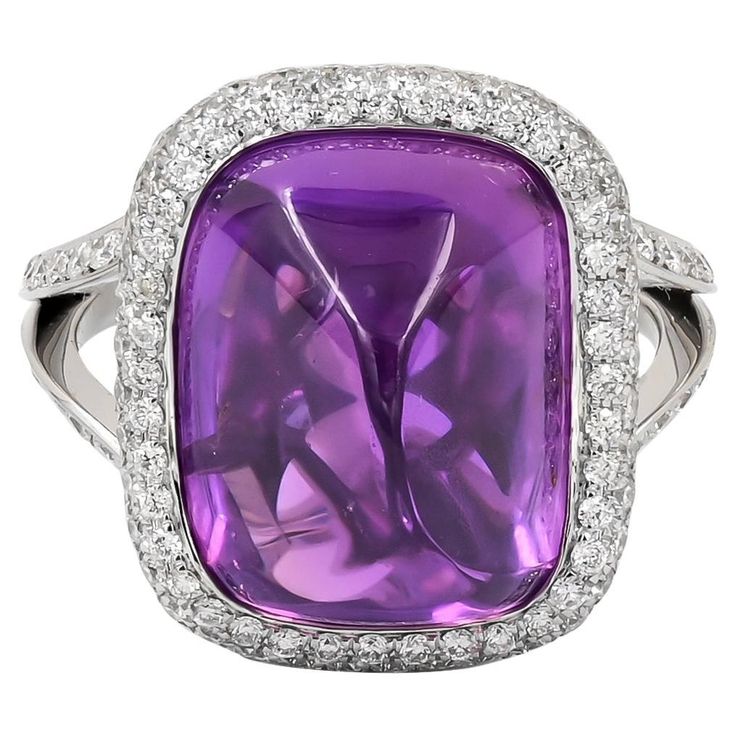 Introducing the epitome of regal elegance, behold the breathtaking 15.83-carat Sugarloaf Cabochon Purple Sapphire Diamond Ring, meticulously crafted by Spectra Fine Jewelry in 2022. This magnificent piece features a mesmerizing purple sapphire of Ceylon origin, boasting its natural beauty with no signs of heating, certified by GRS. The center stone is embraced by a dazzling halo of pave diamonds, extending gracefully onto the band, adding an extra touch of brilliance and sophistication. Encased in platinum, with a total weight of 8.95 grams, this ring exudes luxury and refinement. Sized at 6, with the option for resizing, it's a timeless treasure destined to captivate hearts and steal the spotlight on any occasion. Regal Elegance, Purple Sapphire, Sapphire Diamond Ring, Timeless Treasures, Gem Stone, Sapphire Diamond, Cocktail Rings, Pave Diamonds, Natural Beauty