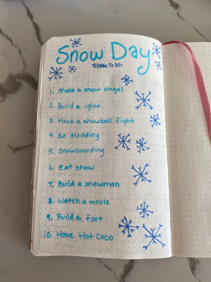 an open notebook with snow days written on it